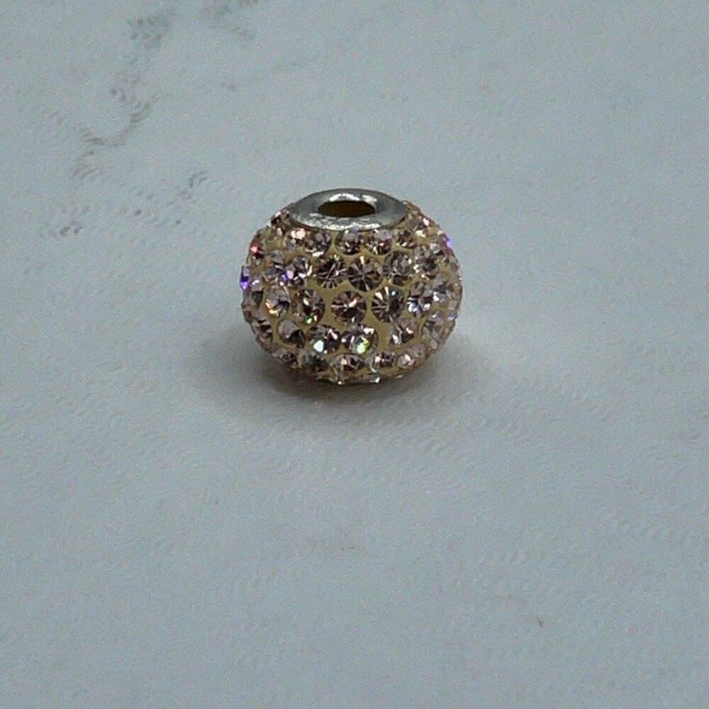 Sterling silver peachy shimmery slider bead that fits most bracelets.